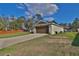 Exterior shows driveway leading to two car garage with green lawn and fence at 14 Hemlock Loop Court, Ocala, FL 34472
