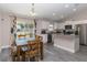 Bright kitchen with white cabinets, granite countertops, stainless steel appliances, and a breakfast bar, creating a modern and functional space at 14 Hemlock Loop Court, Ocala, FL 34472