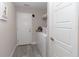 Functional laundry room with a washer, dryer, storage shelving, and a clean, organized layout at 14 Hemlock Loop Court, Ocala, FL 34472