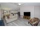 Open-concept living space showcasing a hardwood floors, comfortable seating, and seamless flow to the kitchen at 14 Hemlock Loop Court, Ocala, FL 34472