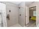 Shower with tiled walls and chrome fixtures, adjacent to the bedroom, offers a convenient and modern bathing space at 14 Hemlock Loop Court, Ocala, FL 34472