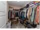 A walk-in closet features ample storage with hanging rods, shelves, and compartments for organizing clothes, shoes and personal items at 14 Hemlock Loop Court, Ocala, FL 34472