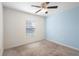 Bedroom with neutral carpet, a ceiling fan, and a window offering natural light at 14 Juniper Drive Crse, Ocala, FL 34480