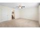 Spacious bedroom with adjacent bath; features ceiling fan and neutral carpet at 14 Juniper Drive Crse, Ocala, FL 34480