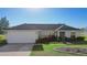 Lovely single-Gathering home with a well-kept lawn, an attached two-car garage, and fresh landscaping at 14 Juniper Drive Crse, Ocala, FL 34480