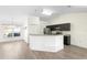 Open-concept kitchen featuring stainless steel appliances and a breakfast bar that overlooks the adjacent dining area at 14 Juniper Drive Crse, Ocala, FL 34480
