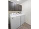 Convenient laundry area equipped with a washing machine, dryer, and upper cabinets for storage at 14 Juniper Drive Crse, Ocala, FL 34480