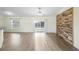 Spacious living room with plank flooring, sliding glass doors to a patio, and a striking accent wall at 14 Juniper Drive Crse, Ocala, FL 34480
