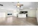 Open-concept living area with ceiling fan, plank flooring, and combined kitchen area at 14 Juniper Drive Crse, Ocala, FL 34480