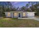 Twilight view of a stylish one-story home, featuring a manicured lawn and an attached garage at 14370 Sw 26 Ln, Ocala, FL 34481