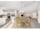 Open-concept dining area featuring modern table set, stainless steel appliances, and seamless connection to the living room at 20764 Sw Starling Dr, Dunnellon, FL 34431