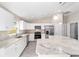 Modern kitchen boasting white cabinetry, stainless steel appliances, granite countertops, and stylish pendant lighting at 20764 Sw Starling Dr, Dunnellon, FL 34431
