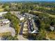 An aerial view of well-maintained townhomes nestled among lush trees with ample parking at 231 Ne 28Th Ave # 103, Ocala, FL 34470