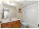 Well-lit bathroom featuring a shower-tub combo, decorative mirror, and a wooden vanity at 231 Ne 28Th Ave # 103, Ocala, FL 34470