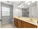 Bathroom featuring double sinks, granite counters, and a large mirror with great lighting at 231 Ne 28Th Ave # 103, Ocala, FL 34470