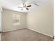 Bright, neutral bedroom featuring carpeted floors, a ceiling fan, and a window offering natural light at 231 Ne 28Th Ave # 103, Ocala, FL 34470