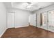 Spacious bedroom featuring wood floors, a ceiling fan, and access to the outdoors through glass doors at 231 Ne 28Th Ave # 103, Ocala, FL 34470