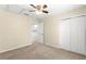 Bright bedroom featuring neutral walls, carpet floors, and a ceiling fan for added comfort at 231 Ne 28Th Ave # 103, Ocala, FL 34470