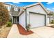 Townhome exterior showcasing a well-maintained lawn and a convenient two-car garage at 231 Ne 28Th Ave # 103, Ocala, FL 34470