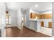 Bright kitchen featuring wood cabinets, breakfast bar, and wood-look floors open to a dining area with french doors at 231 Ne 28Th Ave # 103, Ocala, FL 34470