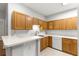 Kitchen view featuring breakfast bar and wood cabinets and tile floors at 231 Ne 28Th Ave # 103, Ocala, FL 34470