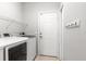 Laundry room view with white walls, washer and dryer, wire rack, and white door at 231 Ne 28Th Ave # 103, Ocala, FL 34470