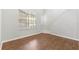 Cozy living room with wood floors, large window, and natural lighting at 231 Ne 28Th Ave # 103, Ocala, FL 34470