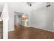 Open living room with high ceilings and wood-look floors, adjacent to the kitchen at 231 Ne 28Th Ave # 103, Ocala, FL 34470