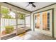 Relaxing screened porch with tiled floors and a view of the fenced yard at 231 Ne 28Th Ave # 103, Ocala, FL 34470