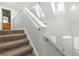 Carpeted staircase leading to the second floor, with ample natural light streaming through windows at 231 Ne 28Th Ave # 103, Ocala, FL 34470