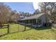 Spacious backyard featuring a screened-in porch and a fence, ideal for relaxation and outdoor activities at 25 Lake Wood Cir, Ocala, FL 34482
