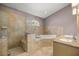 This bathroom is complete with a tiled shower, large tub, and double sink vanity at 25 Lake Wood Cir, Ocala, FL 34482