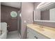 A bathroom with a vanity and an octagonal window at 25 Lake Wood Cir, Ocala, FL 34482
