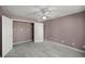 Neutral bedroom is complete with carpeting, neutral walls, an open closet, and a ceiling fan at 25 Lake Wood Cir, Ocala, FL 34482