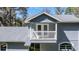 Two-story home featuring a balcony with white railing and view of the roof at 25 Lake Wood Cir, Ocala, FL 34482