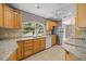 Bright kitchen with granite countertops, stainless steel appliances, and tile flooring at 25 Lake Wood Cir, Ocala, FL 34482