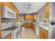 Open kitchen featuring wood cabinets, granite countertops, and stainless steel appliances at 25 Lake Wood Cir, Ocala, FL 34482