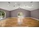 The brightly lit living room boasts hardwood floors, a vaulted ceiling, and a large picture window at 25 Lake Wood Cir, Ocala, FL 34482