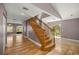Wooden staircase boasts hardwood floors and natural light coming from back door at 25 Lake Wood Cir, Ocala, FL 34482