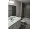 Contemporary bathroom with a tiled shower/tub combo and a sleek white vanity at 27 Laurel Ct, Ocala, FL 34472