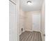 Walk-in closet with a wire shelf, laminate flooring, and a door leading to additional storage at 27 Laurel Ct, Ocala, FL 34472
