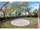 Spacious backyard with a gravel firepit and lush landscaping at 30 Se Wenona Ave, Ocala, FL 34471