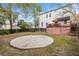 Large backyard with a gravel firepit and a deck in a tranquil setting at 30 Se Wenona Ave, Ocala, FL 34471