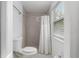 Cozy bathroom with a tiled shower and a white shower curtain next to a window at 30 Se Wenona Ave, Ocala, FL 34471