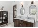 Bathroom featuring double sinks with marble countertops and modern lighting at 30 Se Wenona Ave, Ocala, FL 34471