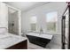 Luxurious bathroom features marble counters, soaking tub and glass enclosed shower at 30 Se Wenona Ave, Ocala, FL 34471