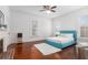 Bright bedroom featuring wood floors, a turquoise bed, and natural light at 30 Se Wenona Ave, Ocala, FL 34471