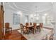 Bright dining room boasts hardwood floors, stylish light fixture and large windows at 30 Se Wenona Ave, Ocala, FL 34471
