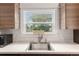 Bright kitchen sink area with stainless steel sink, modern faucet and white backsplash at 30 Se Wenona Ave, Ocala, FL 34471