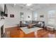 Cozy living room featuring a gray sofa, hardwood floors, and decorative fireplace at 30 Se Wenona Ave, Ocala, FL 34471